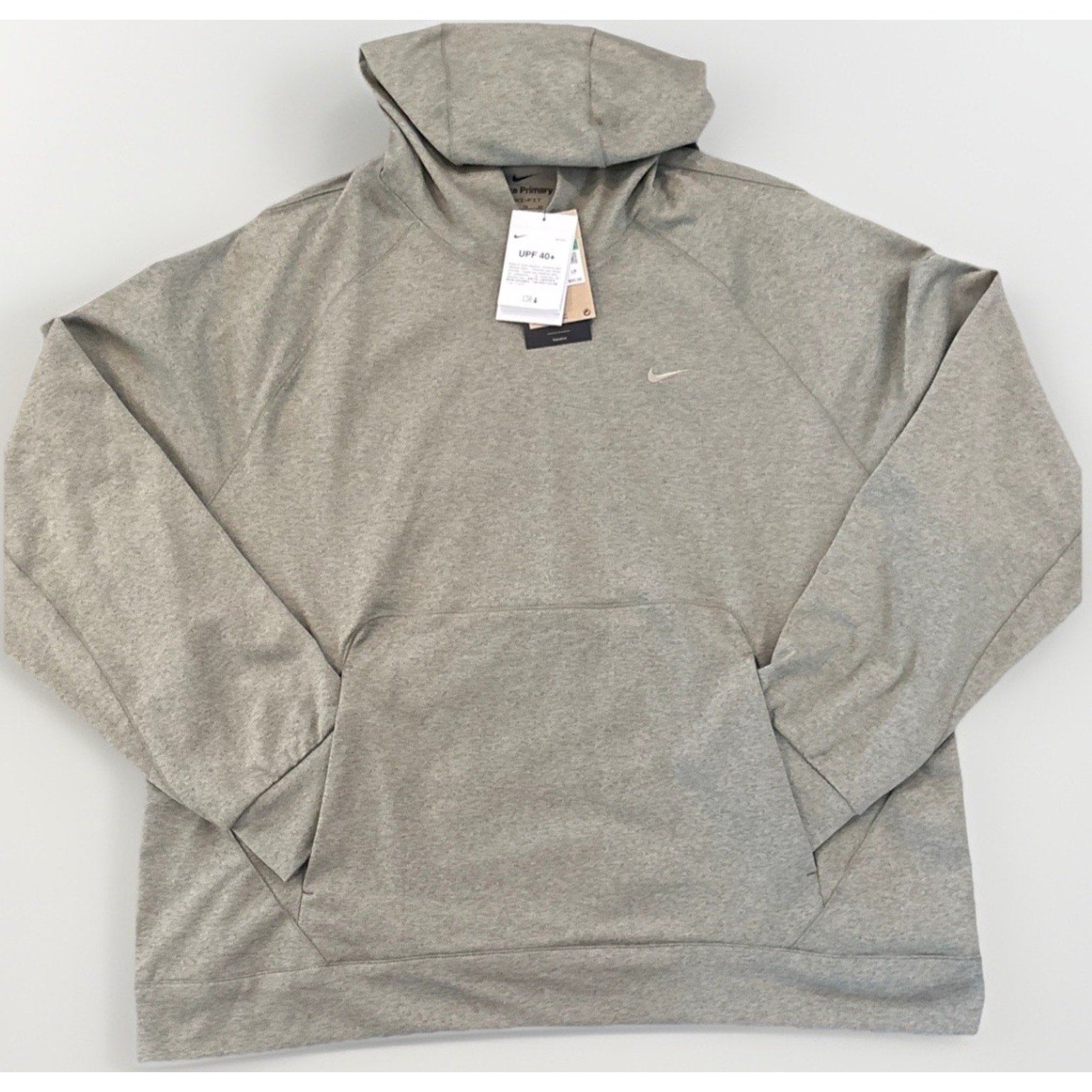 A heather gray Nike pullover hoodie with a small embroidered swoosh on the left chest, laid flat on a light gray background with retail tags attached.